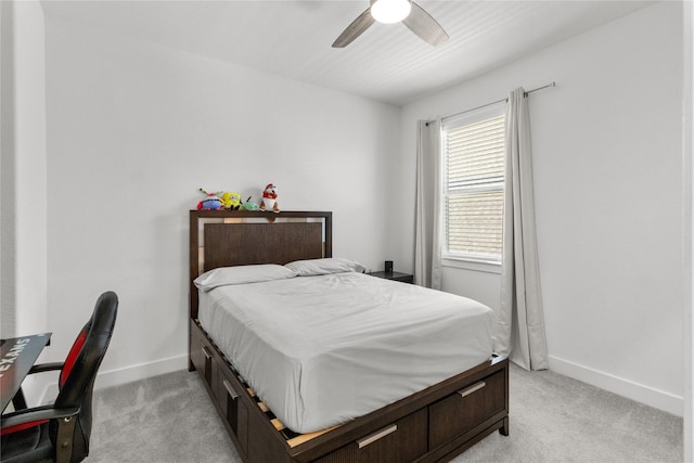 bedroom with ceiling fan, baseboards, and light colored carpet