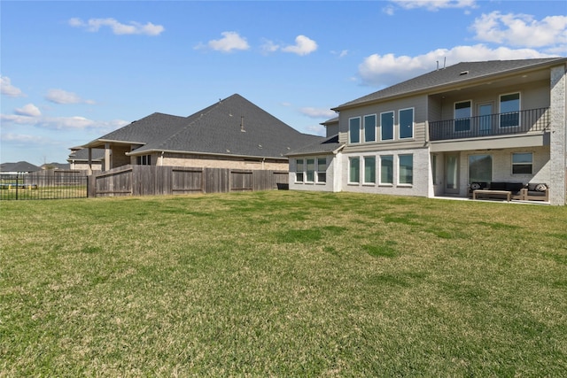 back of house featuring a yard and fence