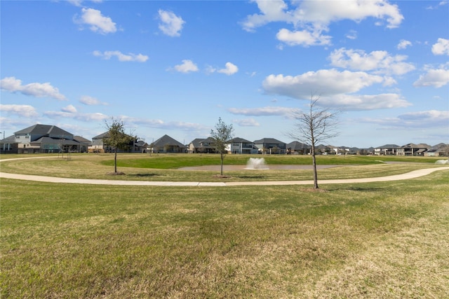 surrounding community with a residential view and a yard