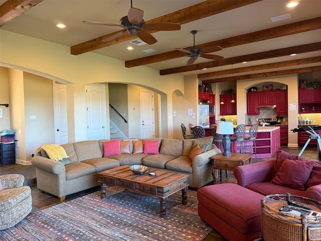 living room featuring ceiling fan and beam ceiling