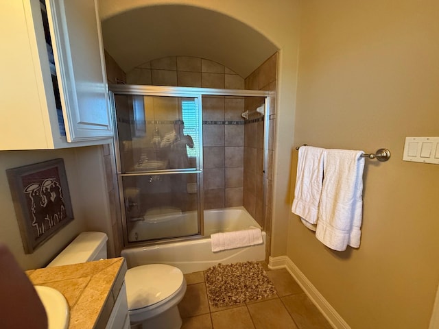 full bathroom featuring enclosed tub / shower combo, vanity, tile patterned floors, and toilet