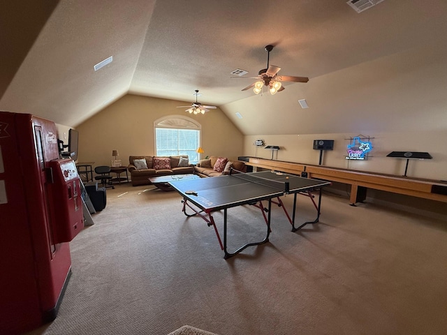 rec room featuring ceiling fan, lofted ceiling, carpet, and a textured ceiling