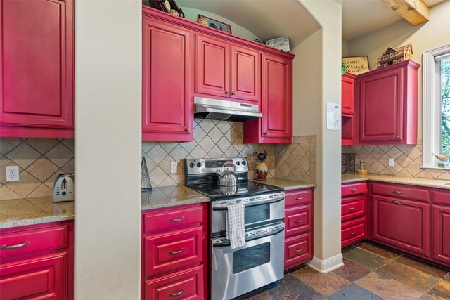 1017 Coventry Rd, Spicewood, TX 78669 - kitchen featuring range with two ovens, under cabinet range hood, decorative backsplash, and dark stone finish floors