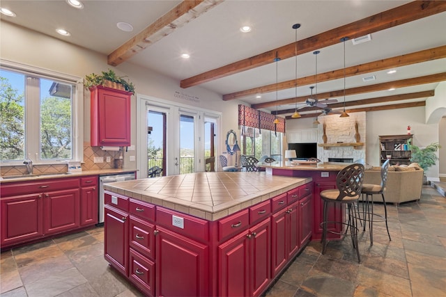 1017 Coventry Rd, Spicewood, TX 78669 - kitchen featuring stone tile flooring, a sink, recessed lighting, decorative backsplash, and beamed ceiling