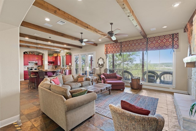 1017 Coventry Rd, Spicewood, TX 78669 - living area with baseboards, stone tile floors, beamed ceiling, recessed lighting, and ceiling fan
