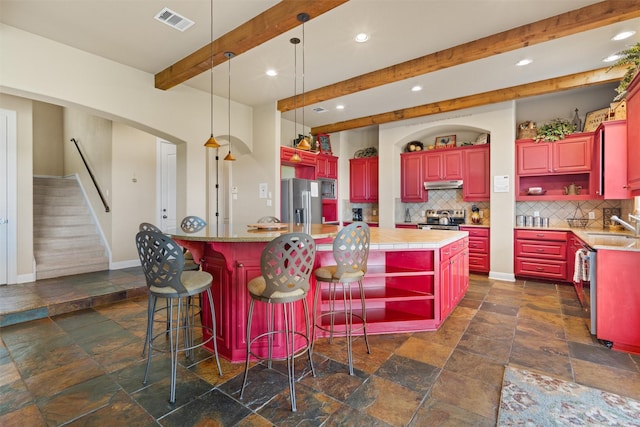 1017 Coventry Rd, Spicewood, TX 78669 - kitchen with open shelves, stone tile floors, appliances with stainless steel finishes, under cabinet range hood, and recessed lighting
