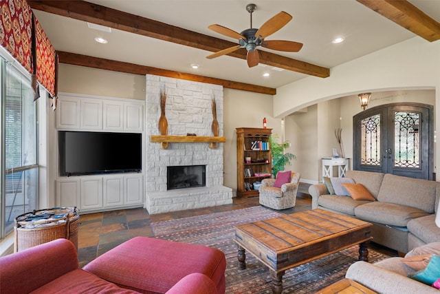 1017 Coventry Rd, Spicewood, TX 78669 - living area featuring arched walkways, beamed ceiling, french doors, a ceiling fan, and recessed lighting