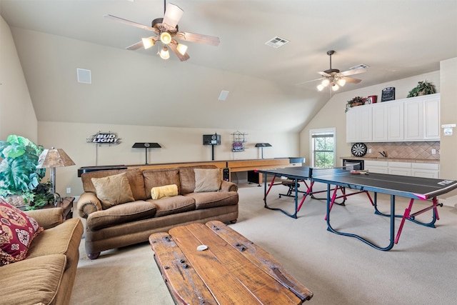 1017 Coventry Rd, Spicewood, TX 78669 - living room featuring a ceiling fan, light carpet, and vaulted ceiling