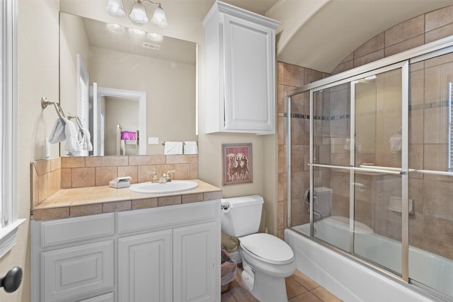 1017 Coventry Rd, Spicewood, TX 78669 - bathroom featuring toilet, vanity, combined bath / shower with glass door, decorative backsplash, and tile patterned flooring