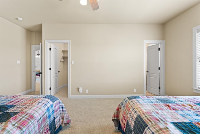 1017 Coventry Rd, Spicewood, TX 78669 - bedroom featuring light colored carpet, a spacious closet, baseboards, and ceiling fan
