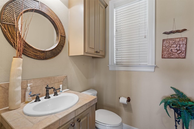 1017 Coventry Rd, Spicewood, TX 78669 - half bathroom featuring toilet, vanity, and tasteful backsplash