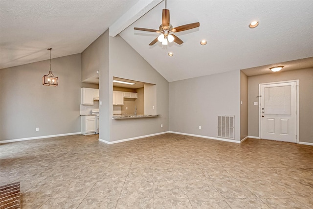 unfurnished living room featuring high vaulted ceiling, beamed ceiling, sink, ceiling fan, and a textured ceiling