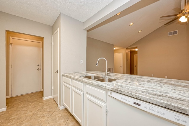 kitchen featuring lofted ceiling, sink, white dishwasher, light stone countertops, and white cabinets