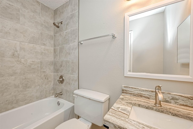 full bathroom with vanity, toilet, and tiled shower / bath combo