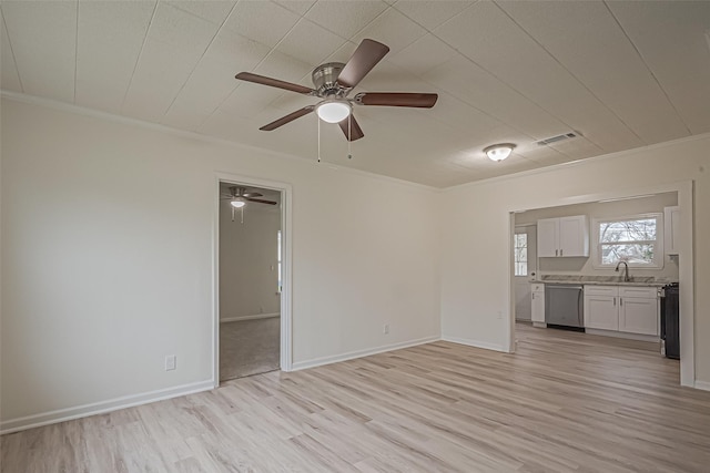 unfurnished living room featuring light hardwood / wood-style floors, sink, and ornamental molding