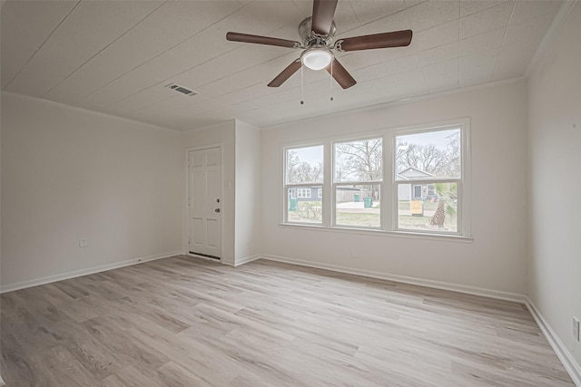 spare room featuring ornamental molding, light hardwood / wood-style flooring, and ceiling fan