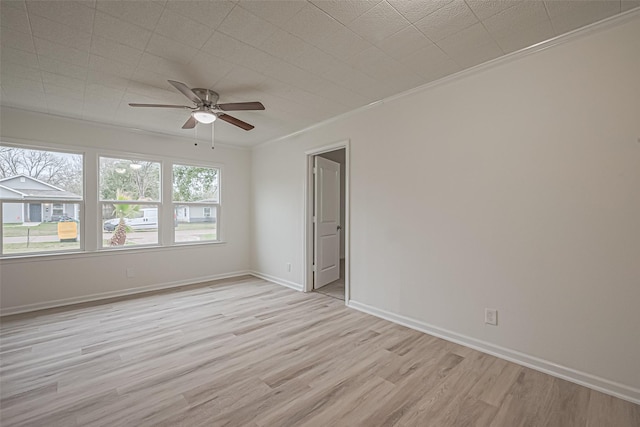 unfurnished room with crown molding, ceiling fan, and light hardwood / wood-style flooring