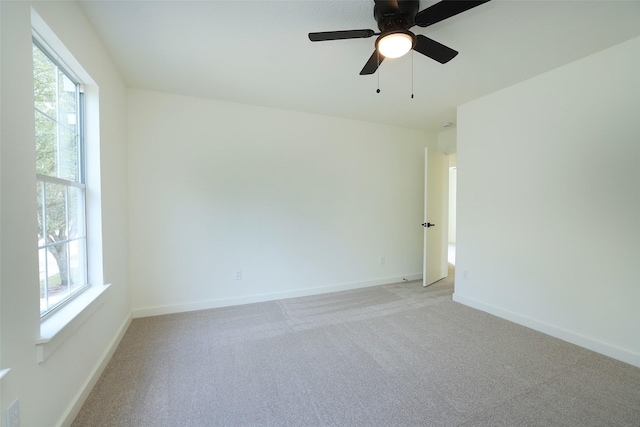 carpeted empty room featuring plenty of natural light