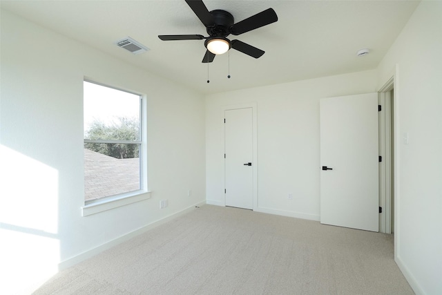 unfurnished bedroom featuring light carpet and ceiling fan