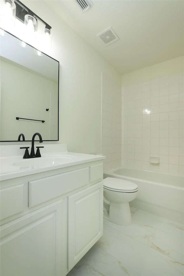 full bathroom featuring toilet, vanity, and tiled shower / bath