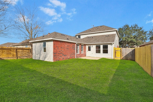 rear view of house featuring a patio area and a lawn