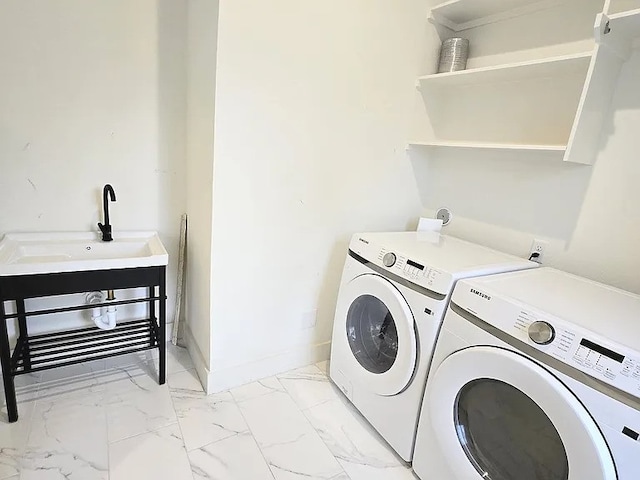 laundry room with washer and clothes dryer and sink