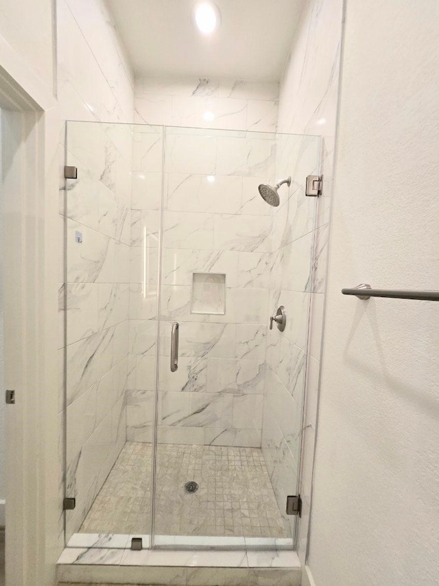 bathroom with a shower with shower door