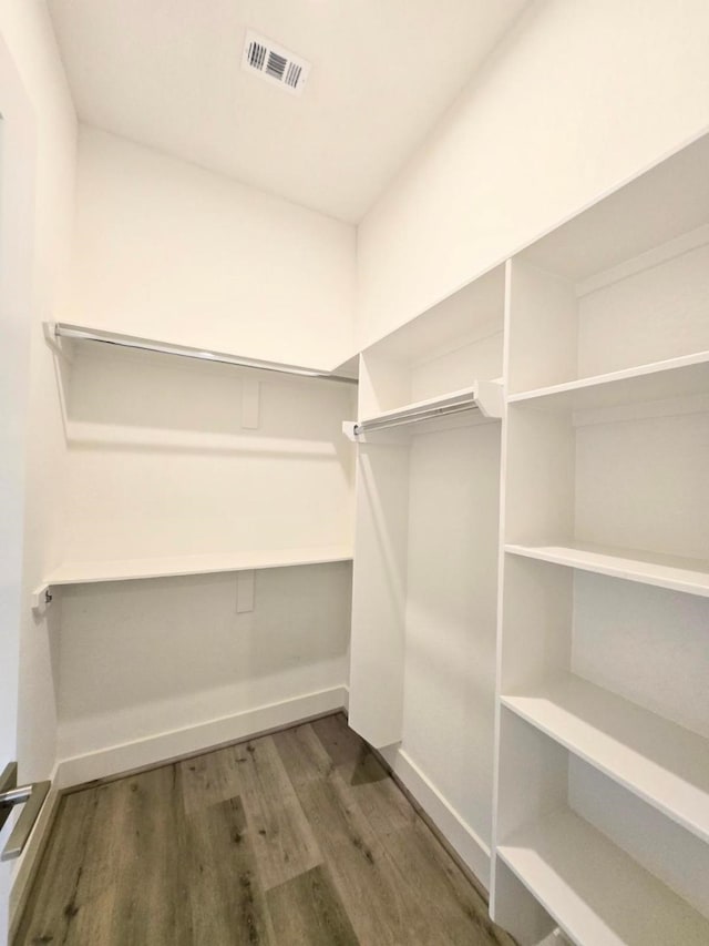 walk in closet featuring dark wood-type flooring