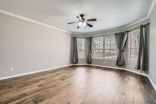 spare room with crown molding, ceiling fan, wood-type flooring, and a textured ceiling