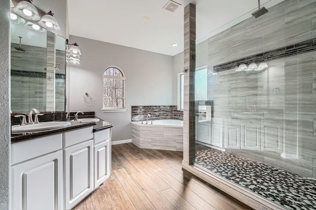 bathroom with vanity, wood-type flooring, and separate shower and tub