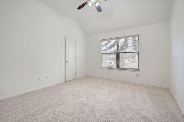 unfurnished room with vaulted ceiling, light colored carpet, and ceiling fan