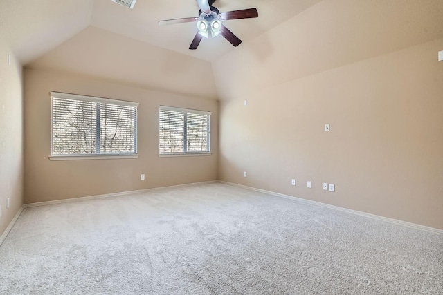 empty room with ceiling fan, lofted ceiling, and light carpet