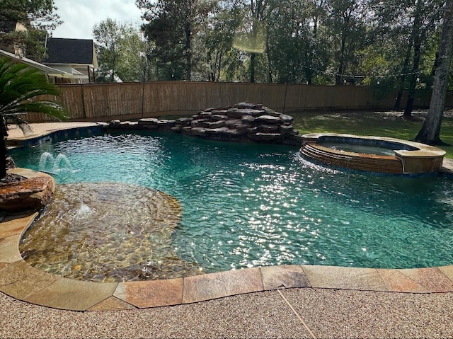 view of pool featuring an in ground hot tub