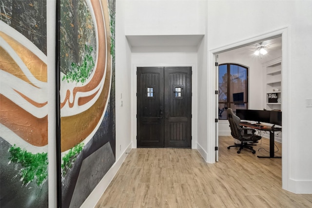 entryway featuring baseboards and wood finished floors