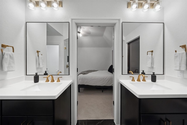 ensuite bathroom with two vanities, a sink, and ensuite bathroom