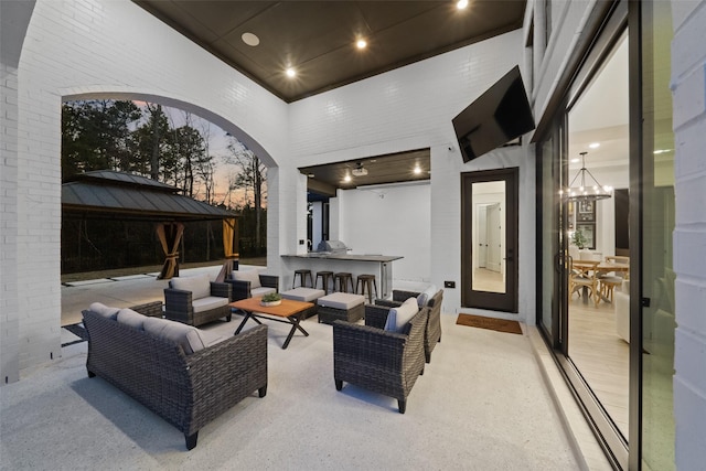 view of patio with outdoor dry bar, an outdoor living space, and a gazebo