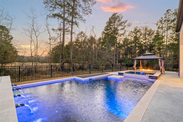 view of swimming pool featuring an in ground hot tub, a fenced backyard, a fenced in pool, and a gazebo