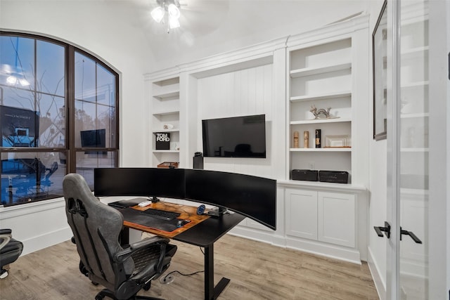 office featuring built in features and light wood-type flooring