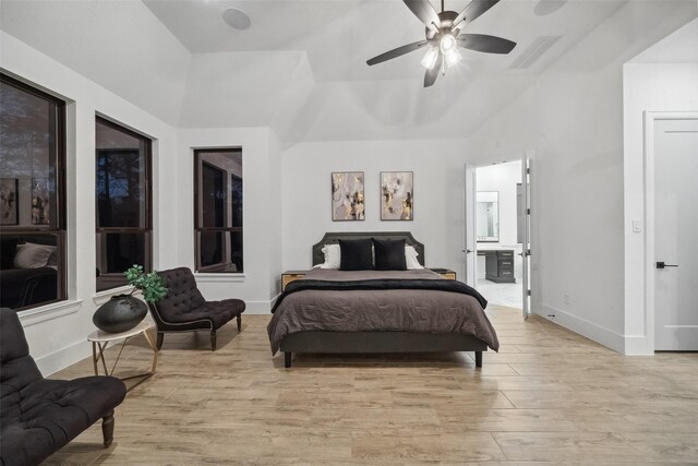 bedroom featuring a ceiling fan, visible vents, baseboards, light wood finished floors, and ensuite bath