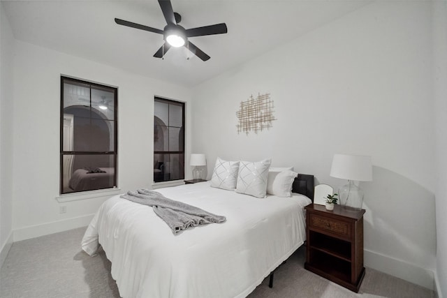 carpeted bedroom featuring a ceiling fan and baseboards