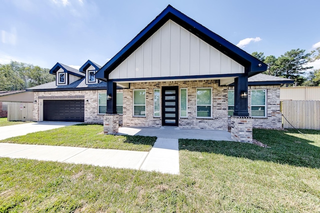 view of front of home with a garage and a front lawn