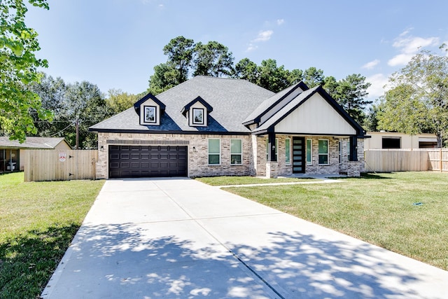 view of front of property featuring a porch, a garage, and a front lawn