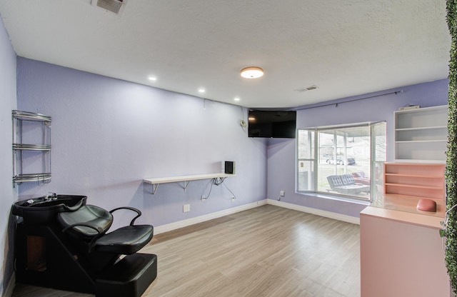 living area featuring hardwood / wood-style floors and a textured ceiling