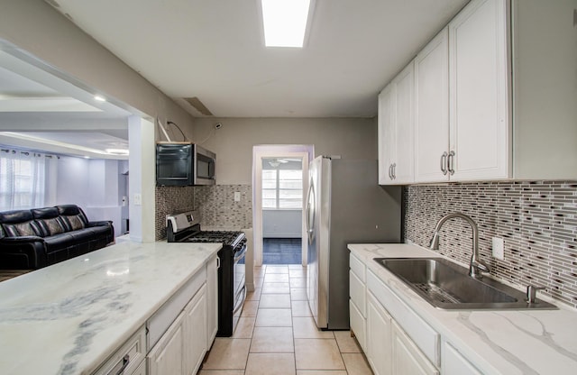 kitchen featuring light tile patterned floors, stainless steel appliances, sink, and white cabinets