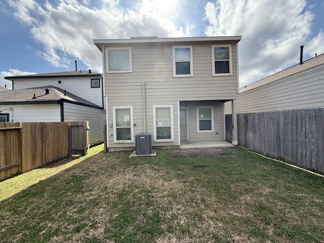 rear view of house featuring a lawn, a patio, and central air condition unit