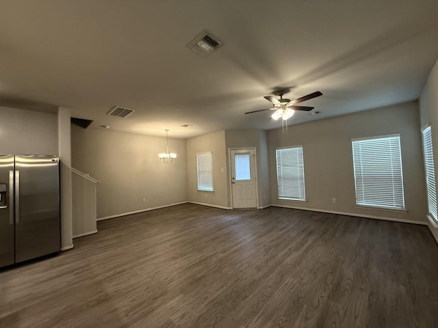 unfurnished living room featuring dark hardwood / wood-style floors and ceiling fan with notable chandelier