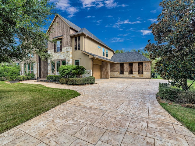 view of front of home with a garage and a front lawn