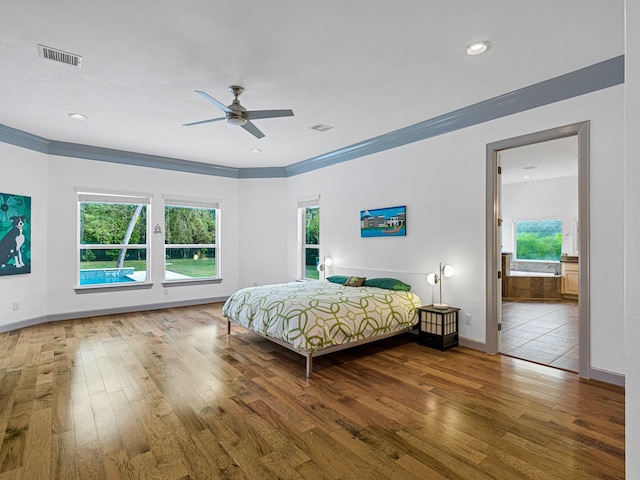 bedroom with crown molding and hardwood / wood-style flooring