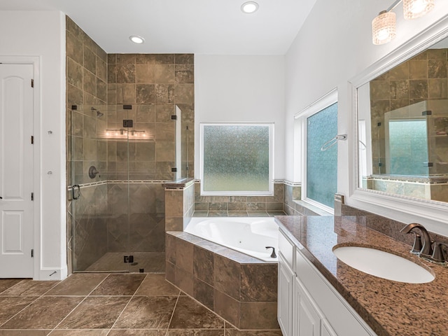 bathroom with independent shower and bath and vanity