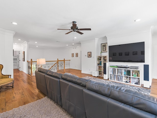 living room featuring hardwood / wood-style floors, ornamental molding, and ceiling fan